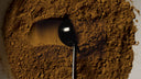 Measuring spoon in mushroom cacao powder, a caffeine-free coffee alternative
