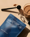 GAYA Beauty Sleep supplement package with a glass of tea on a beige surface